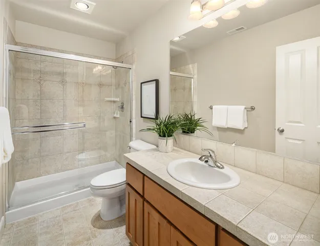a bathroom with a sink toilet and shower