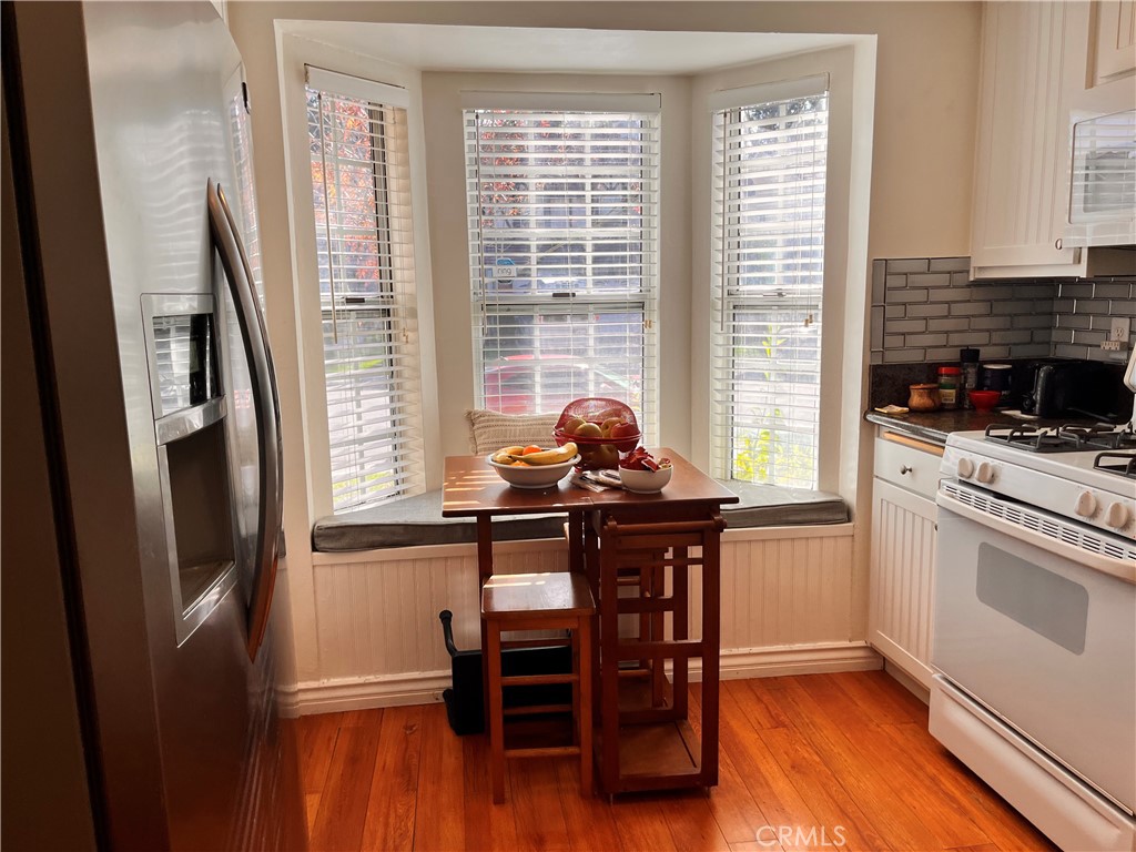 19849 Collins Road Canyon Country, CA 91351 - Photo 11 of 32 a kitchen with stainless steel appliances a table chairs and a refrigerator