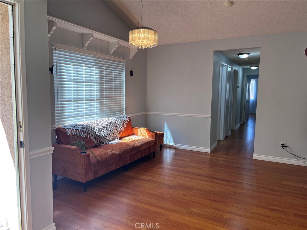 19849 Collins Road Canyon Country, CA 91351 - Photo 8 of 32 a living room with furniture and a chandelier