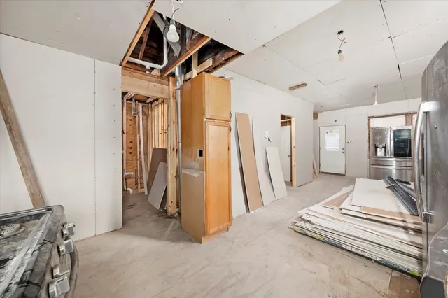 a view of a hallway with stairs and toys