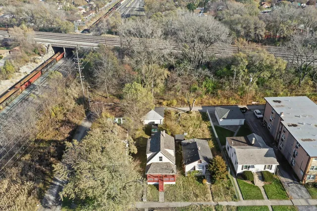 an aerial view of a house with a yard and staircase
