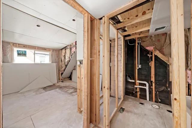 a view of an entryway with wooden floor and windows