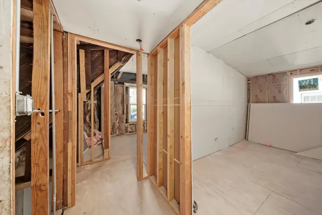a view of hallway with wooden floor and stairs