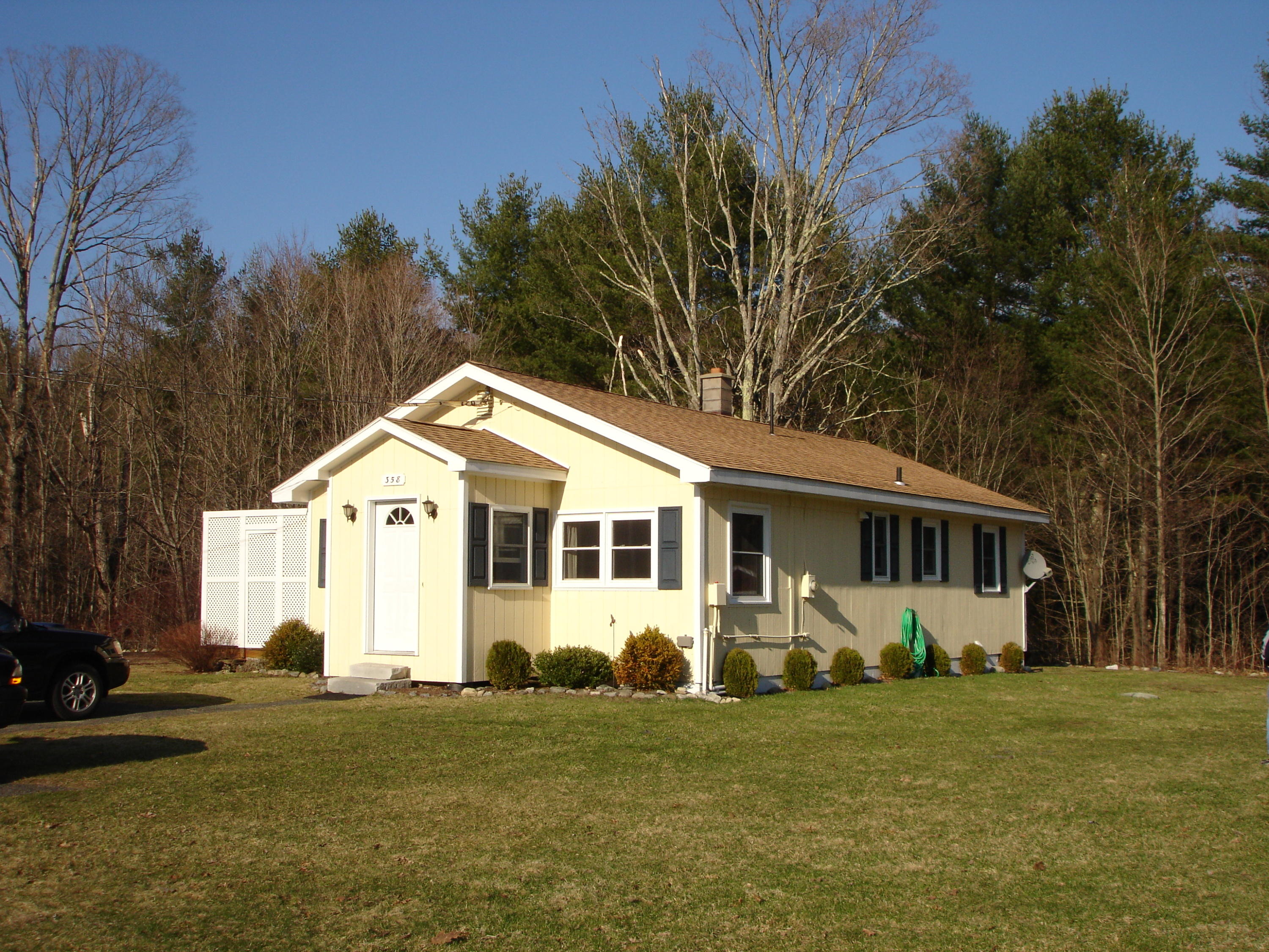 a front view of a house with a garden
