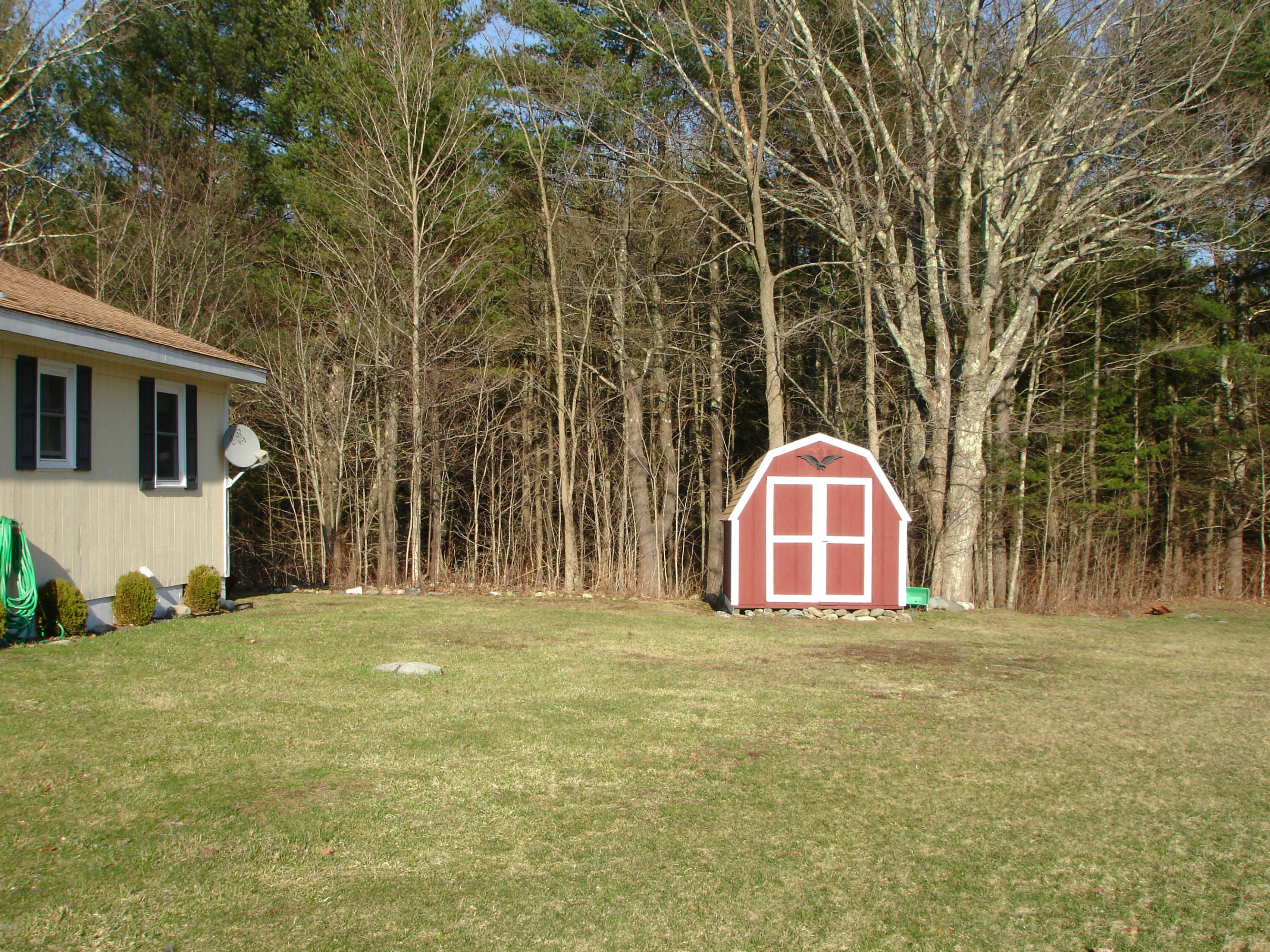 358 North Main Road Otis, MA 01253 - Photo 16 of 18 a view of a yard in front of a house with large trees