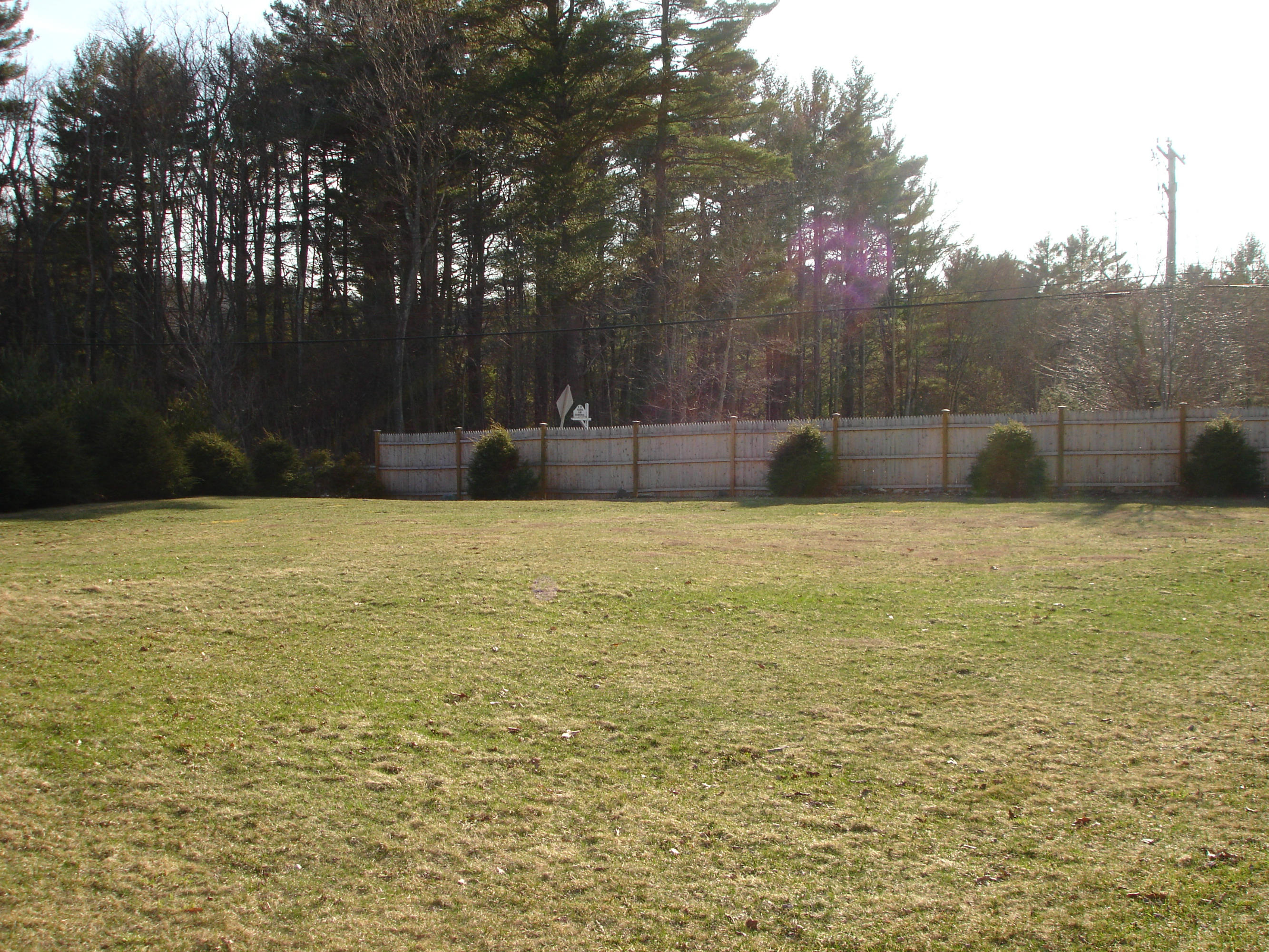 358 North Main Road Otis, MA 01253 - Photo 10 of 18 a swimming pool that has lawn chairs with wooden fence