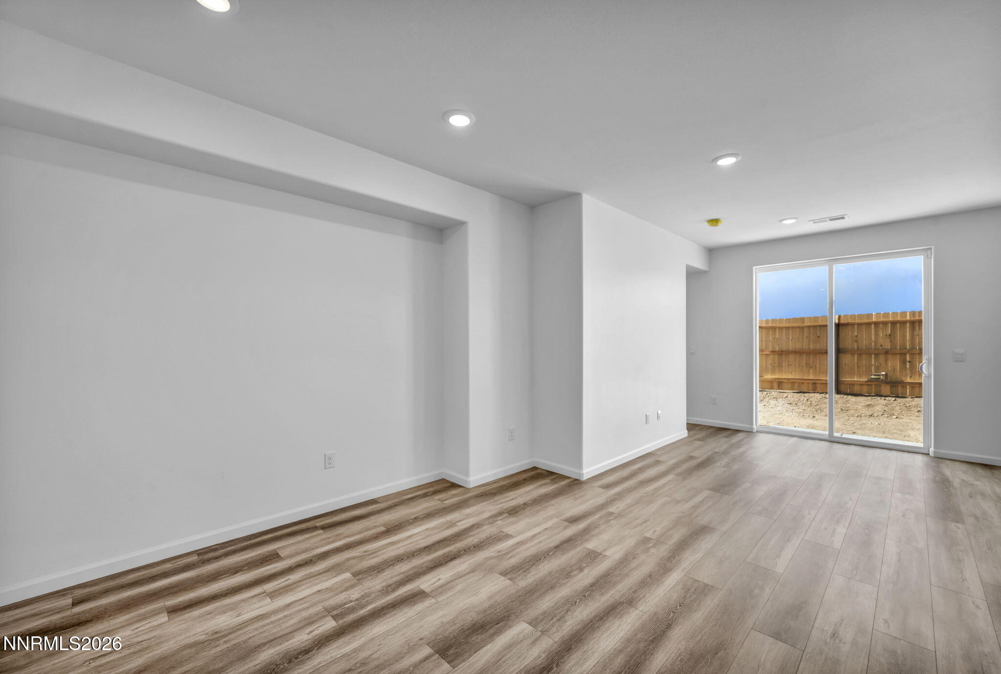 6676 Morgan Mill Road, Unit HOMESITE 14 Carson City, NV 89701 - Photo 10 of 24 a view of an empty room with wooden floor and a window