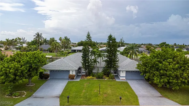 an aerial view of residential houses with outdoor space and river