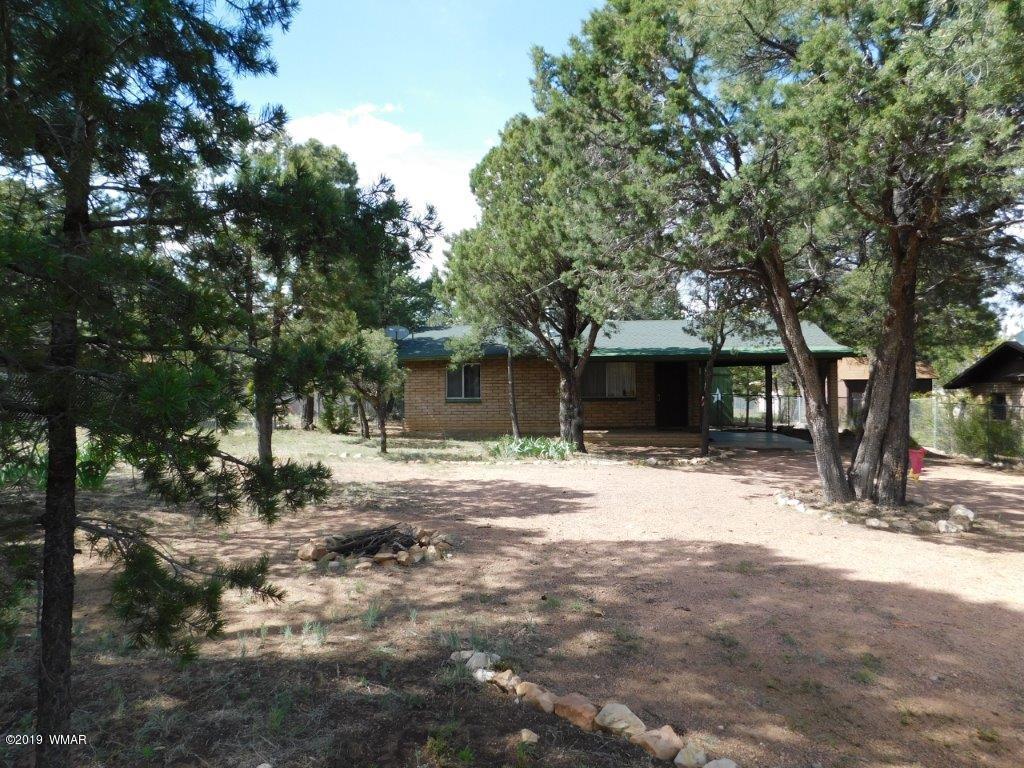 2136 Cottontail Road Overgaard, AZ 85933 - Photo 1 of 23 a front view of a house with a yard and trees