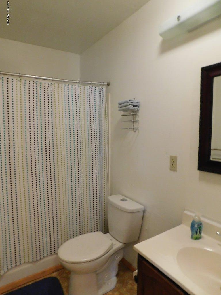 2136 Cottontail Road Overgaard, AZ 85933 - Photo 12 of 23 a bathroom with a sink a toilet and mirror