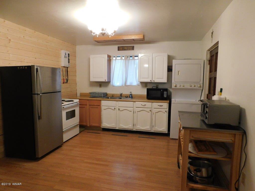 2136 Cottontail Road Overgaard, AZ 85933 - Photo 19 of 23 a kitchen with stainless steel appliances a refrigerator sink and cabinets