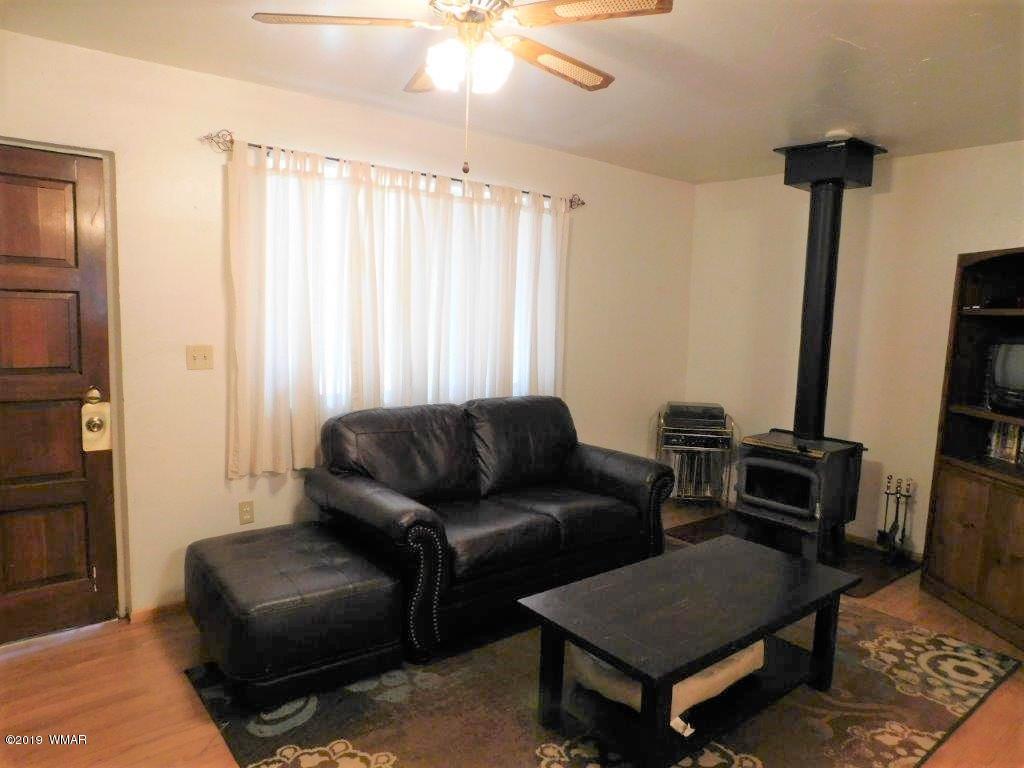 2136 Cottontail Road Overgaard, AZ 85933 - Photo 20 of 23 a living room with furniture and a window