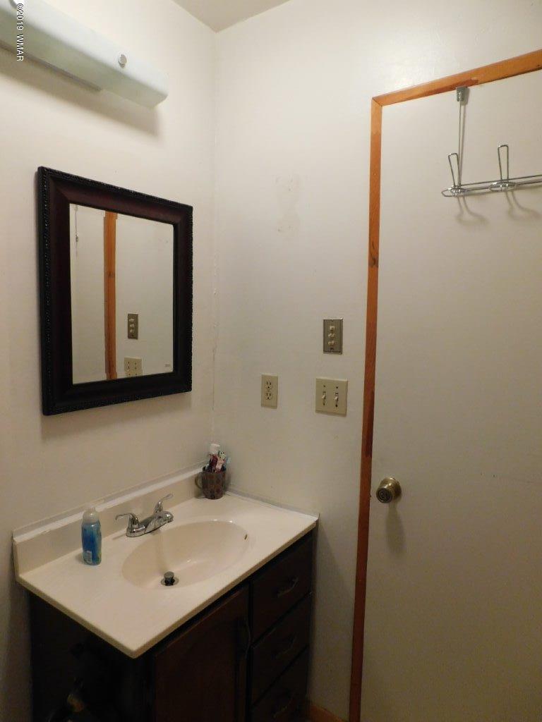 2136 Cottontail Road Overgaard, AZ 85933 - Photo 23 of 23 a bathroom with a sink and a mirror