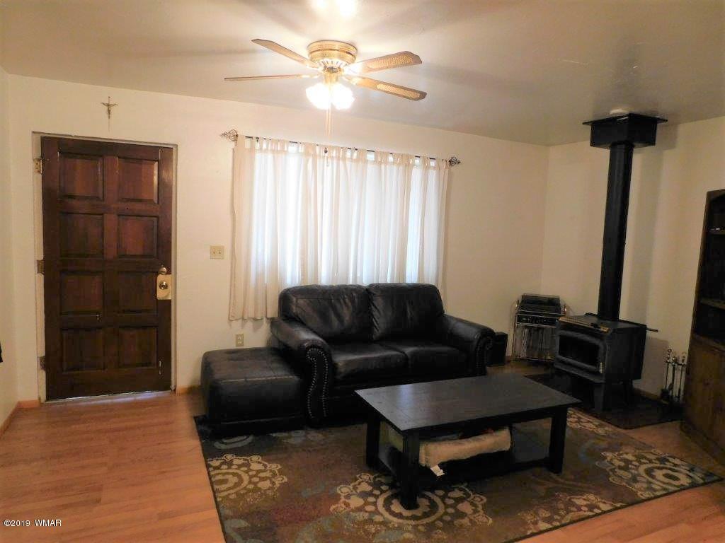 2136 Cottontail Road Overgaard, AZ 85933 - Photo 7 of 23 a living room with furniture and a rug