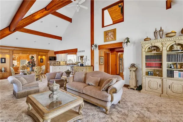 a living room with fireplace furniture and a large window