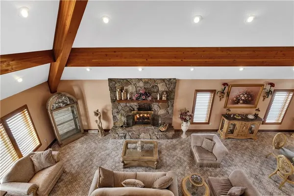 a living room with furniture fireplace and wooden floor