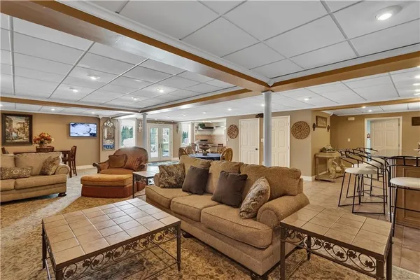 a dining hall with stainless steel appliances granite countertop a table and chairs