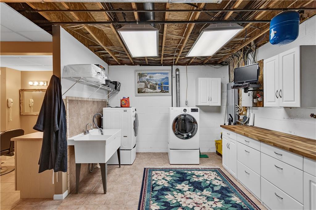 204 South Links Avenue Butler, PA 16001 - Photo 41 of 49 a utility room with sink dryer and washer