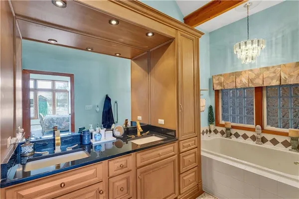 a bathroom with a double vanity sink and a bathtub