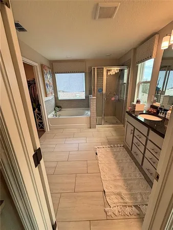 a bathroom with a sink a mirror and shower