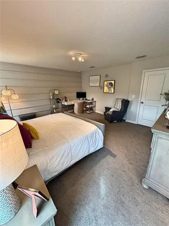 a bedroom with a bed and glass windows