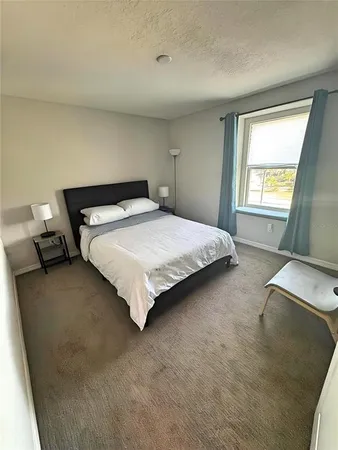 a bedroom with a bed and window