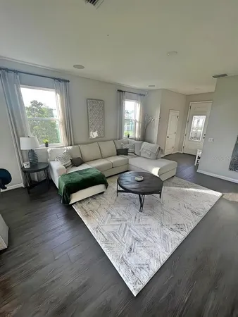 a living room with furniture and a large window