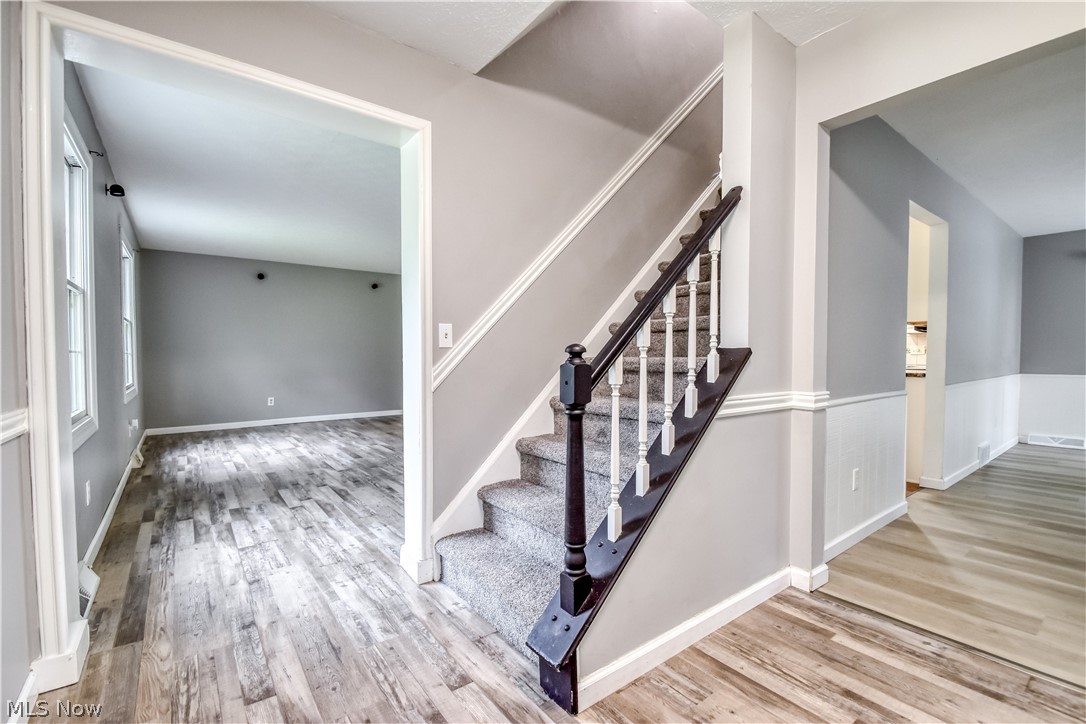 8242 Starburst Road Mentor, OH 44060 - Photo 25 of 37 Staircase featuring dark wood handrails and carpeted treads