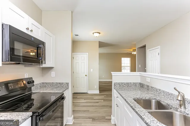 a kitchen that has a sink and a stove in it