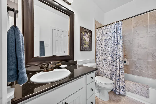 a front view of a house with garden and patio