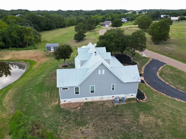 an aerial view of a house with pool