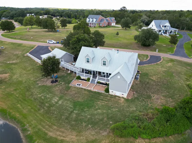 an aerial view of a house with outdoor space and street view