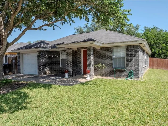 a view of a house with a yard and sitting area