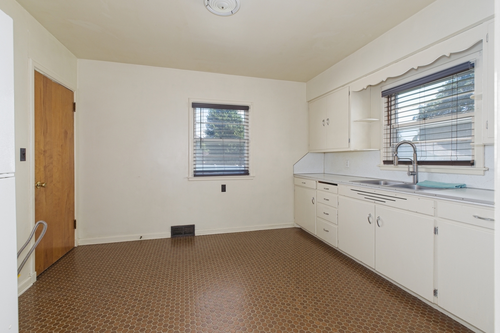 1019 North 3rd Street Clinton, IA 52732 - Photo 10 of 17 a kitchen with sink cabinets and window