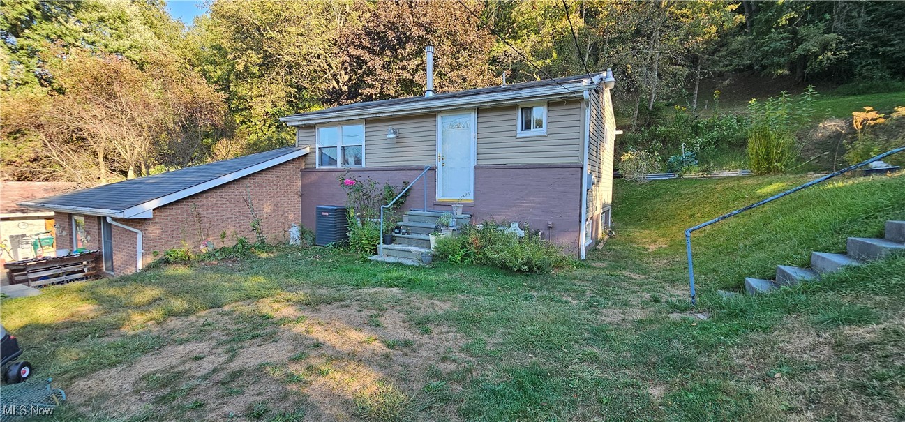 327 Fairview Road Chester, WV 26034 - Photo 1 of 29 View of front of property featuring brick siding, a front lawn, and a view of trees