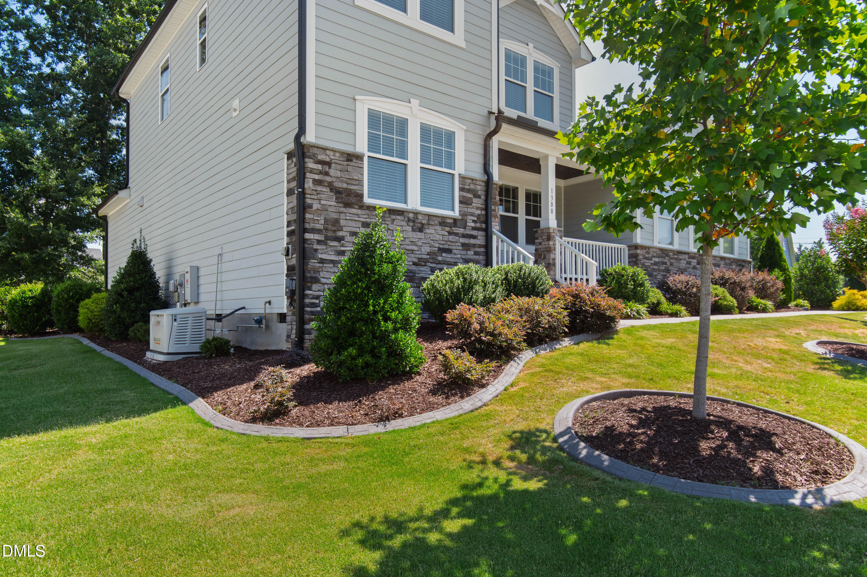1300 Commons Ford Place Apex, NC 27539 - Photo 2 of 70 a view of a backyard with table and chairs under an umbrella