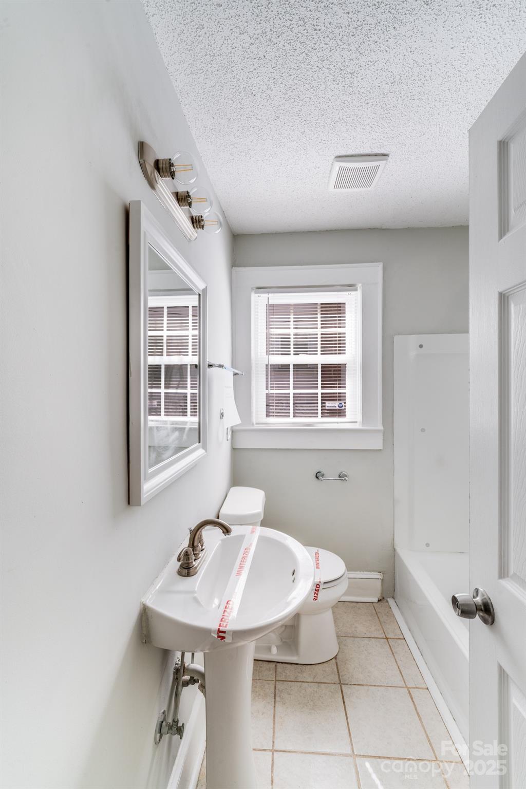 3138 Morson Street Charlotte, NC 28208 - Photo 13 of 21 a bathroom with a sink mirror and a window