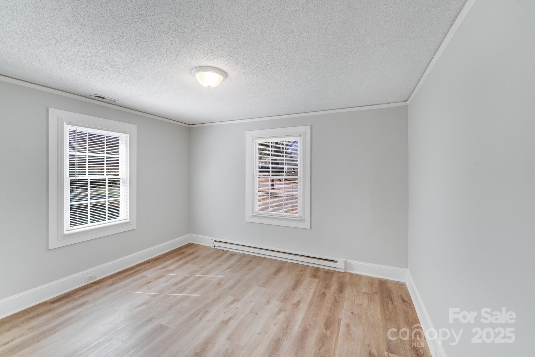 3138 Morson Street Charlotte, NC 28208 - Photo 15 of 21 an empty room with wooden floor and windows