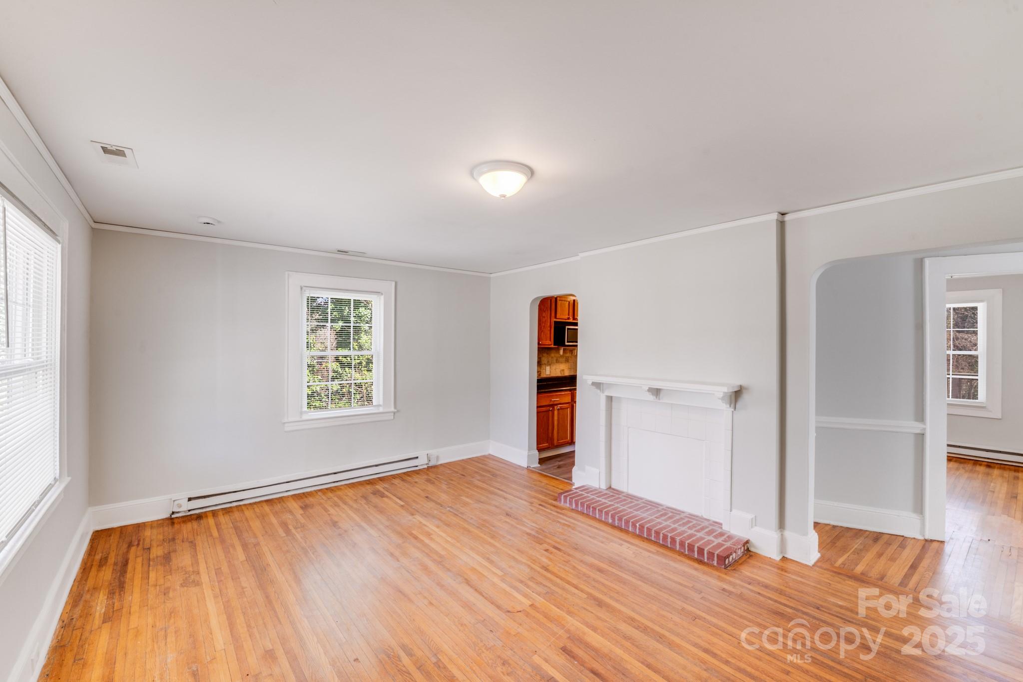 3138 Morson Street Charlotte, NC 28208 - Photo 3 of 21 a view of empty room with wooden floor and fan