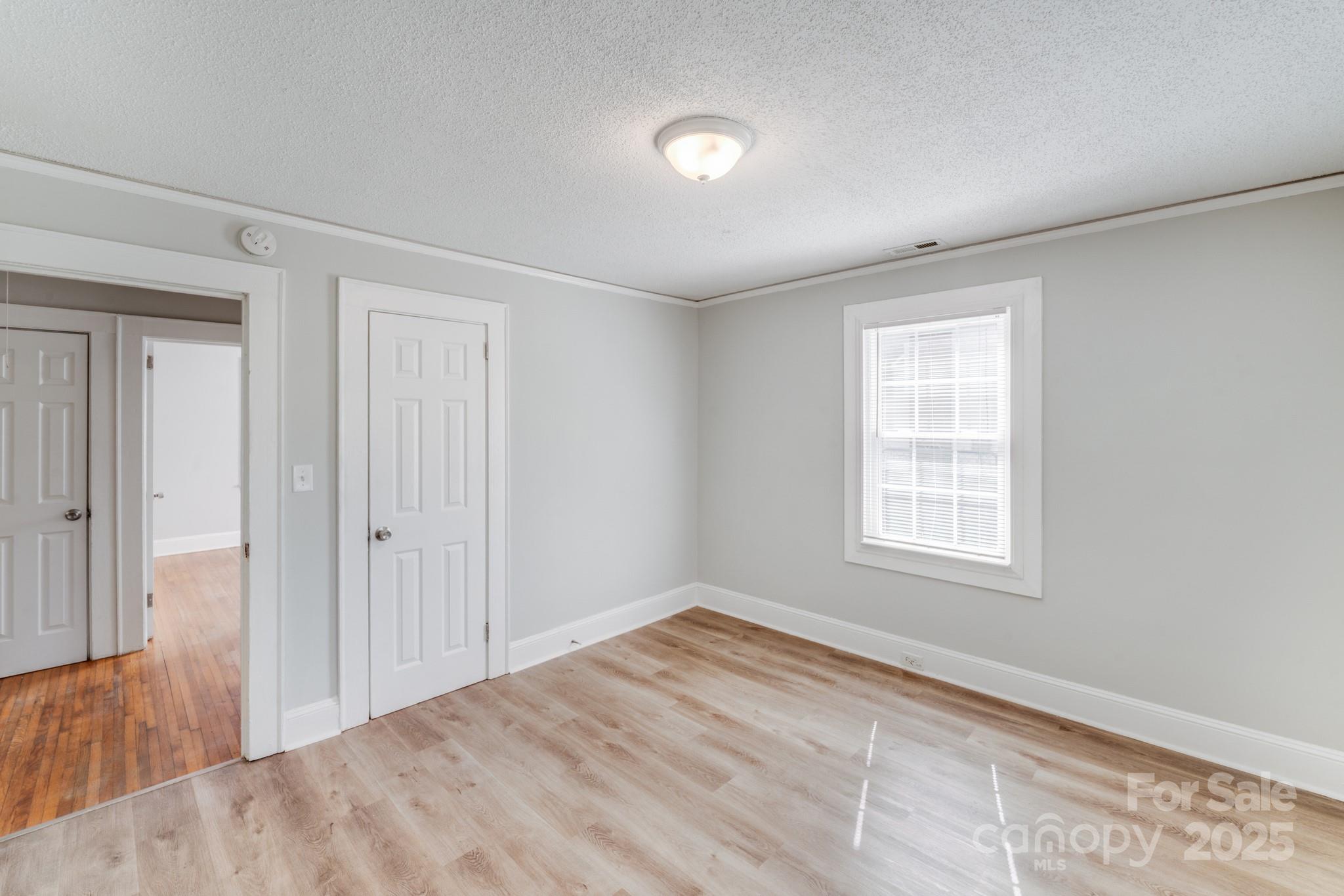 3138 Morson Street Charlotte, NC 28208 - Photo 5 of 21 a view of an empty room with wooden floor and a window