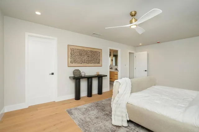 a bedroom with a bed and a painting on the wall