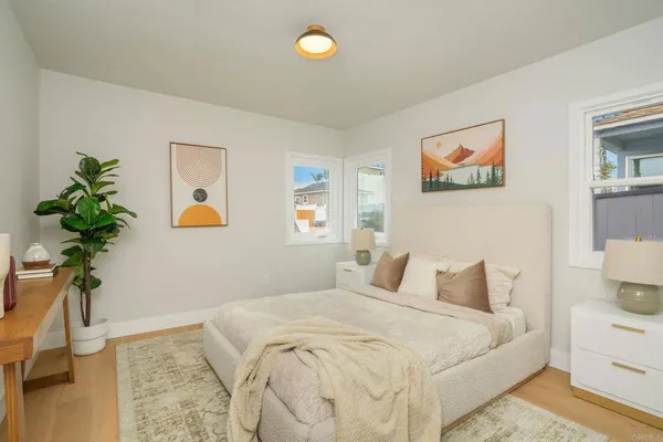 a bedroom with a bed and a potted plant