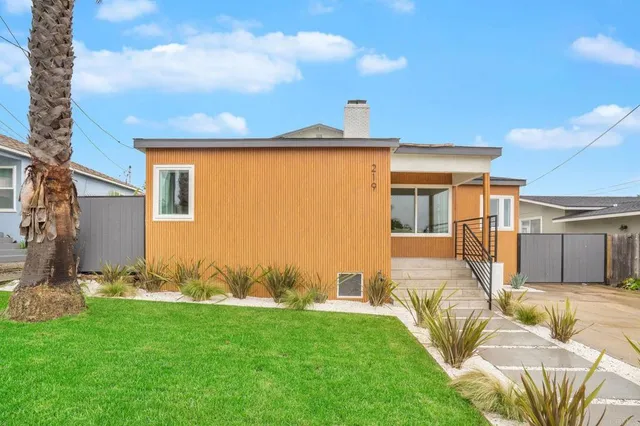 a view of a backyard with table and chairs with wooden fence
