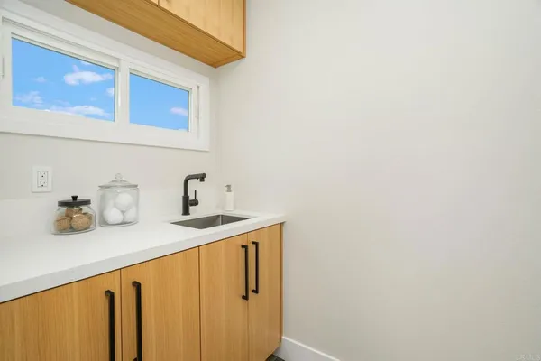 a kitchen with a sink and cabinets