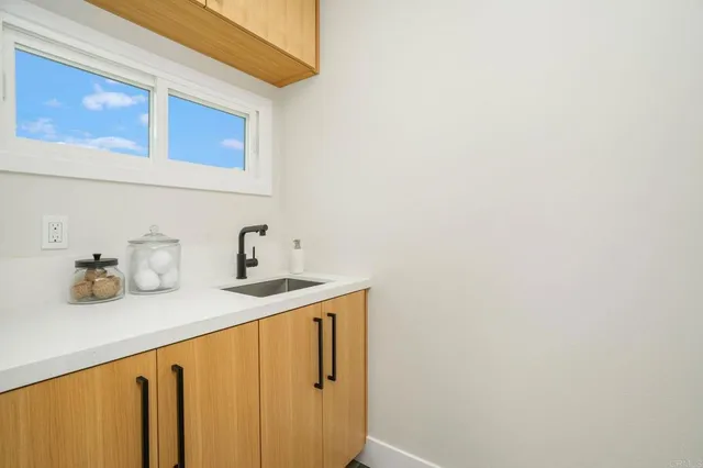 a kitchen with a sink and cabinets