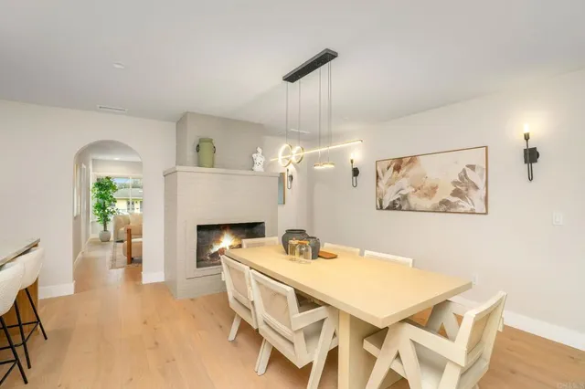 a view of a dining room with furniture and a fireplace