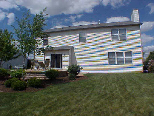 2501 Ridgefield Drive Belvidere, IL 61008 - Photo 3 of 6 a front view of a house with garden