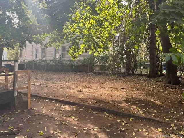a view of a yard with trees