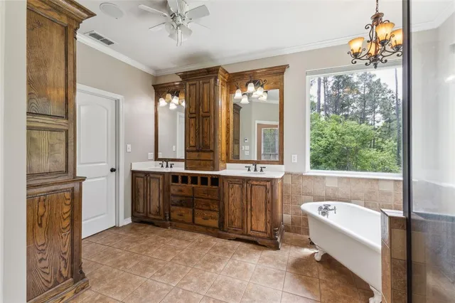 wooden floor in an empty room with a chandelier fan