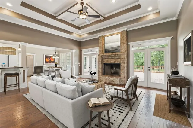 a living room with furniture fireplace and a large window